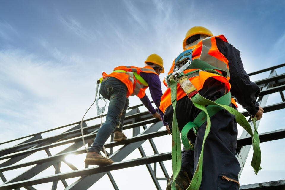 Workers with safety equipment on roof
